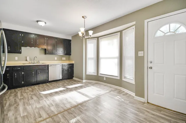 a large kitchen with a stove a sink dishwasher and a refrigerator