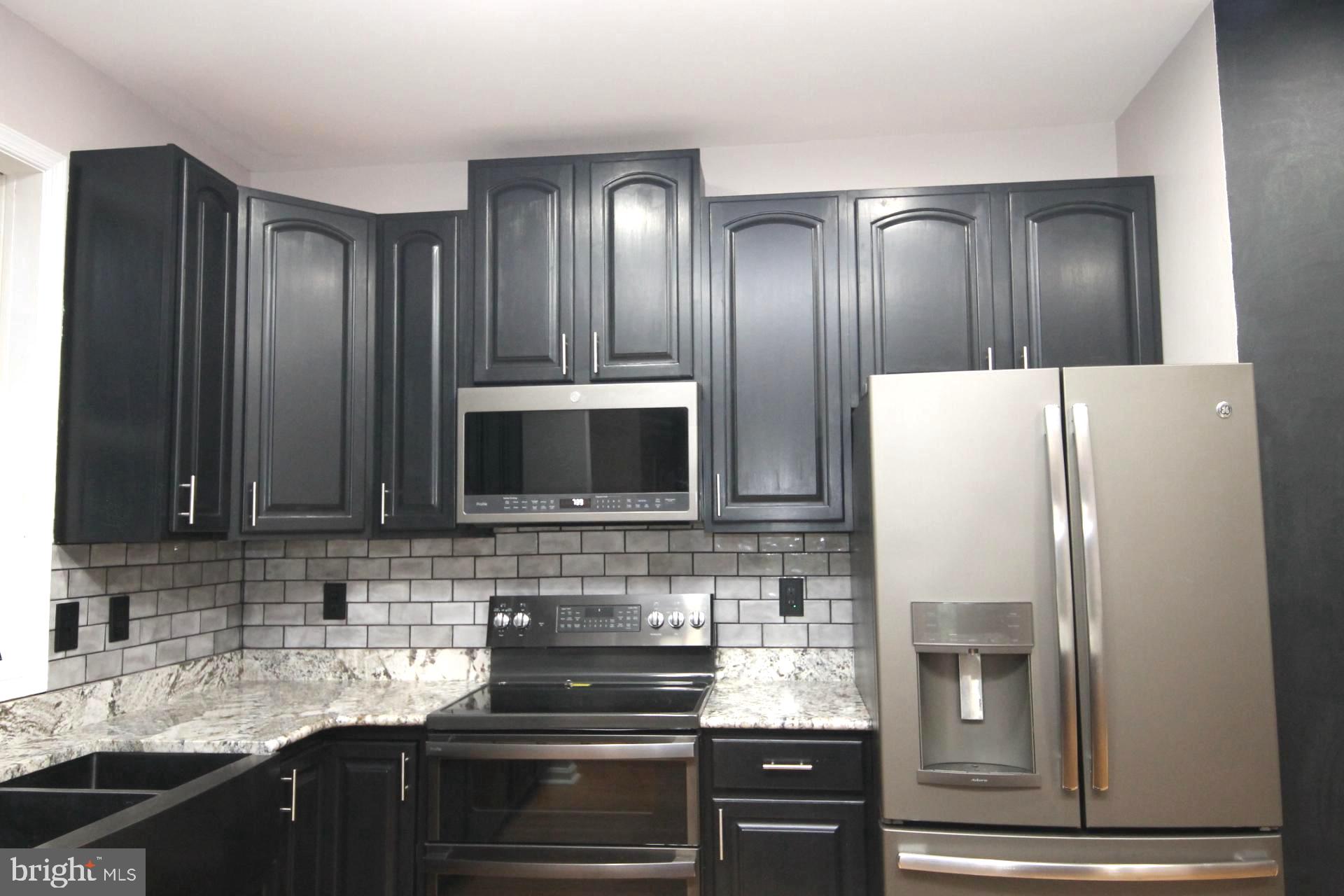 4695 Sands Road Harwood, MD 20776 - Photo 10 of 49 Sleek modern kitchen with dark cabinetry.