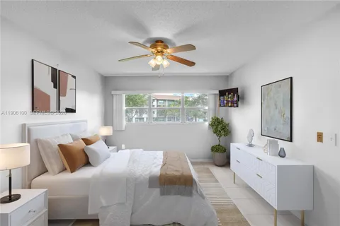 a bedroom with a bed and a potted plant