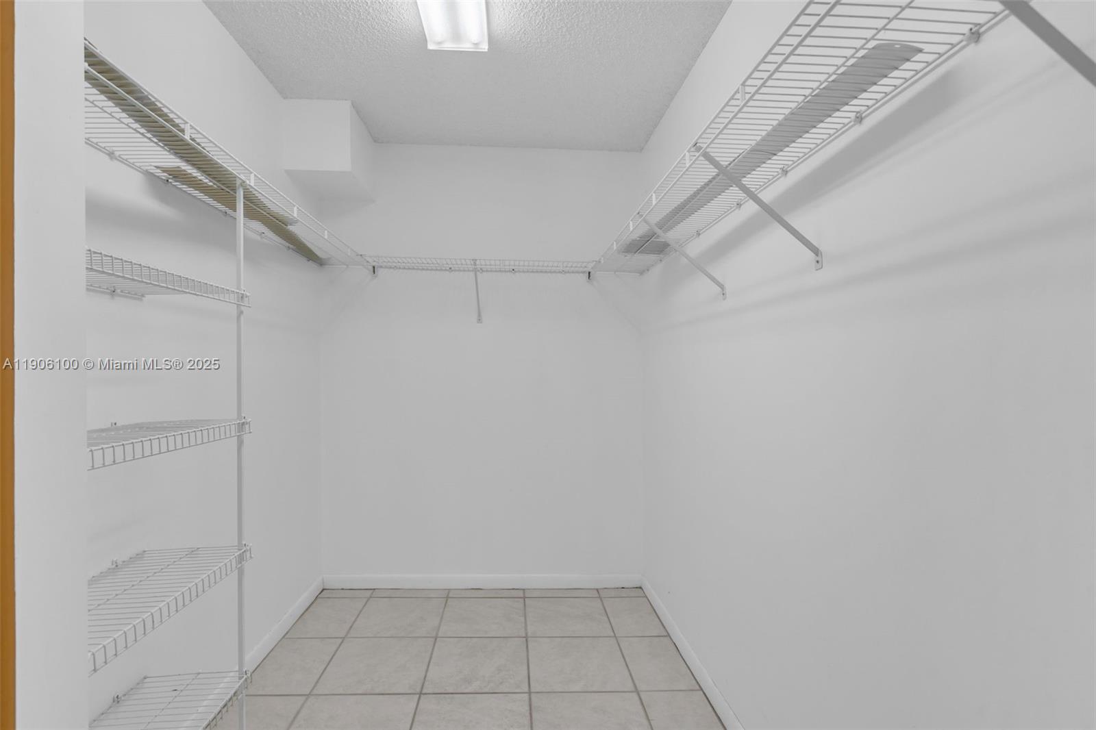 550 Southwest 137th Avenue, Unit 208L Pembroke Pines, FL 33027 - Photo 9 of 18 a view of an empty walk in closet