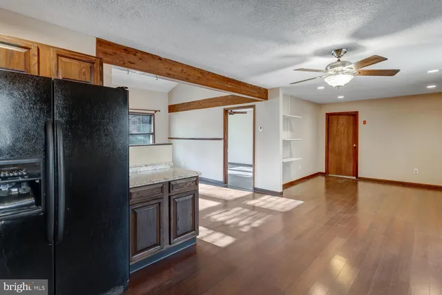 a kitchen with stainless steel appliances a refrigerator and a stove