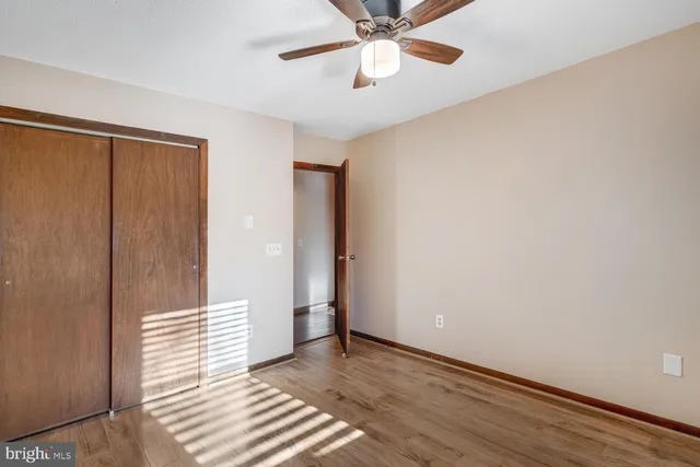 a view of a room with wooden floor and white walls