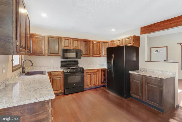 a kitchen with a refrigerator stove and sink
