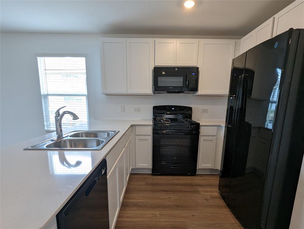 152 Avre Loop Kyle, TX 78640 - Photo 3 of 24 A well-appointed kitchen showcasing elegant counters and contemporary appliances.