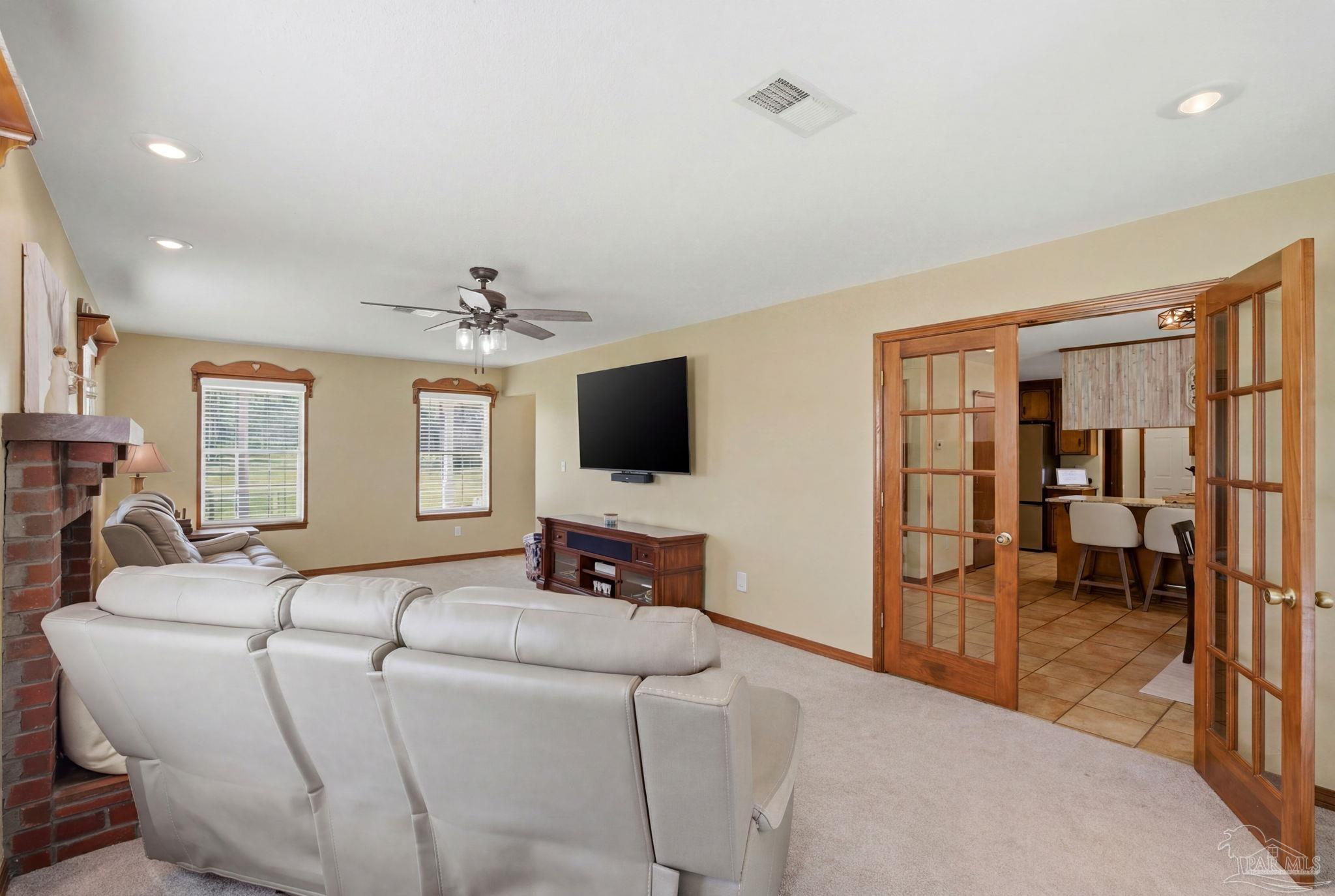 6870 Martin Road Milton, FL 32570 - Photo 18 of 48 a living room with furniture and a flat screen tv