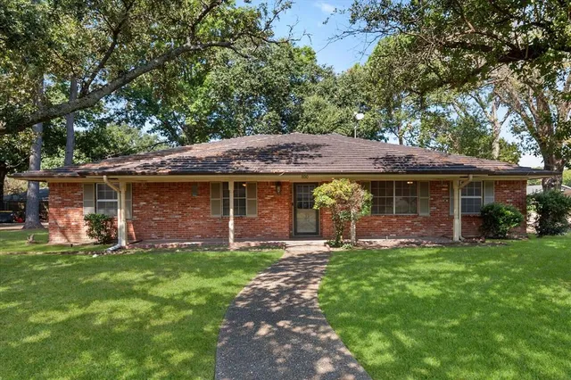 a view of a house with a yard and sitting area