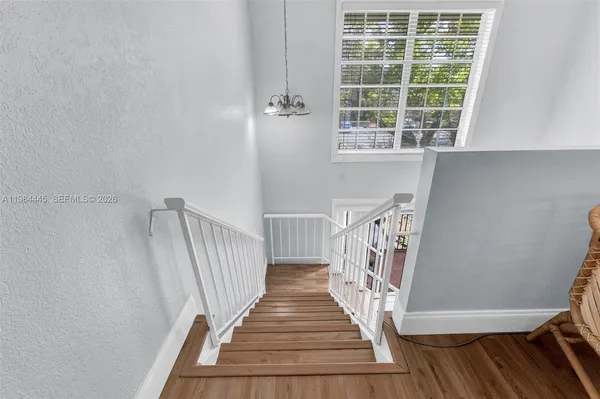 a view of entryway with wooden floor and stairs