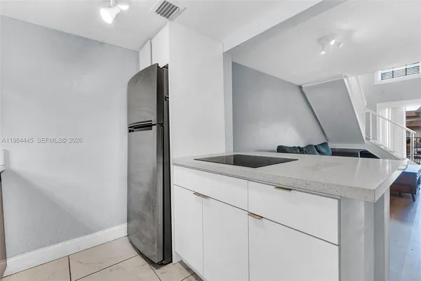 a kitchen with a sink and a refrigerator