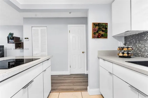 a kitchen with a sink and cabinets