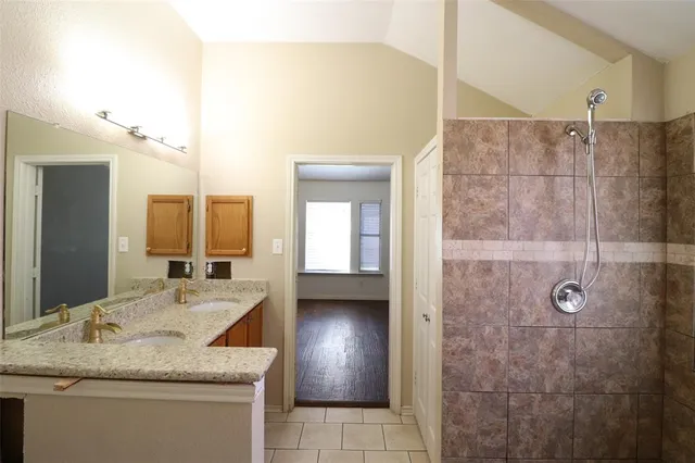 a bathroom with a bathtub and shower