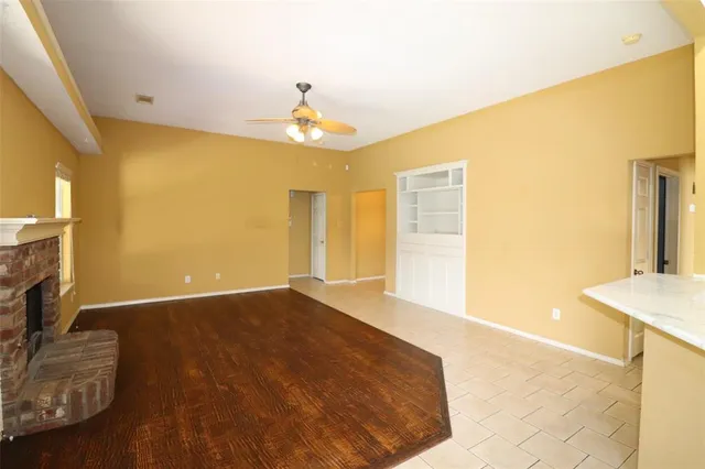 a view of an empty room with a fireplace