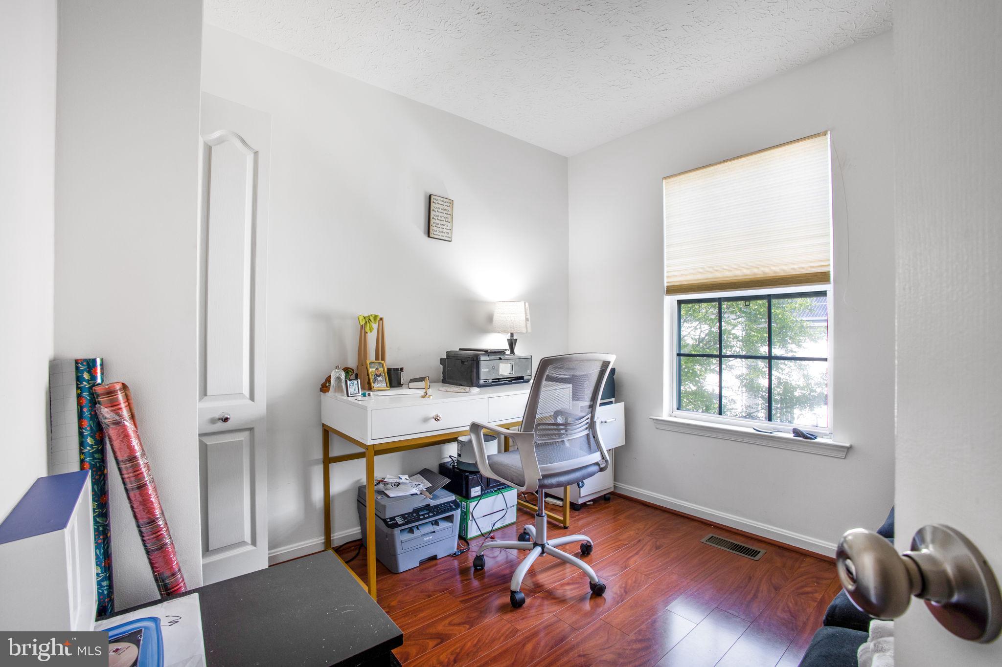 9820 Berrywood Court Bowie, MD 20721 - Photo 13 of 43 a view of a workspace with furniture and a window