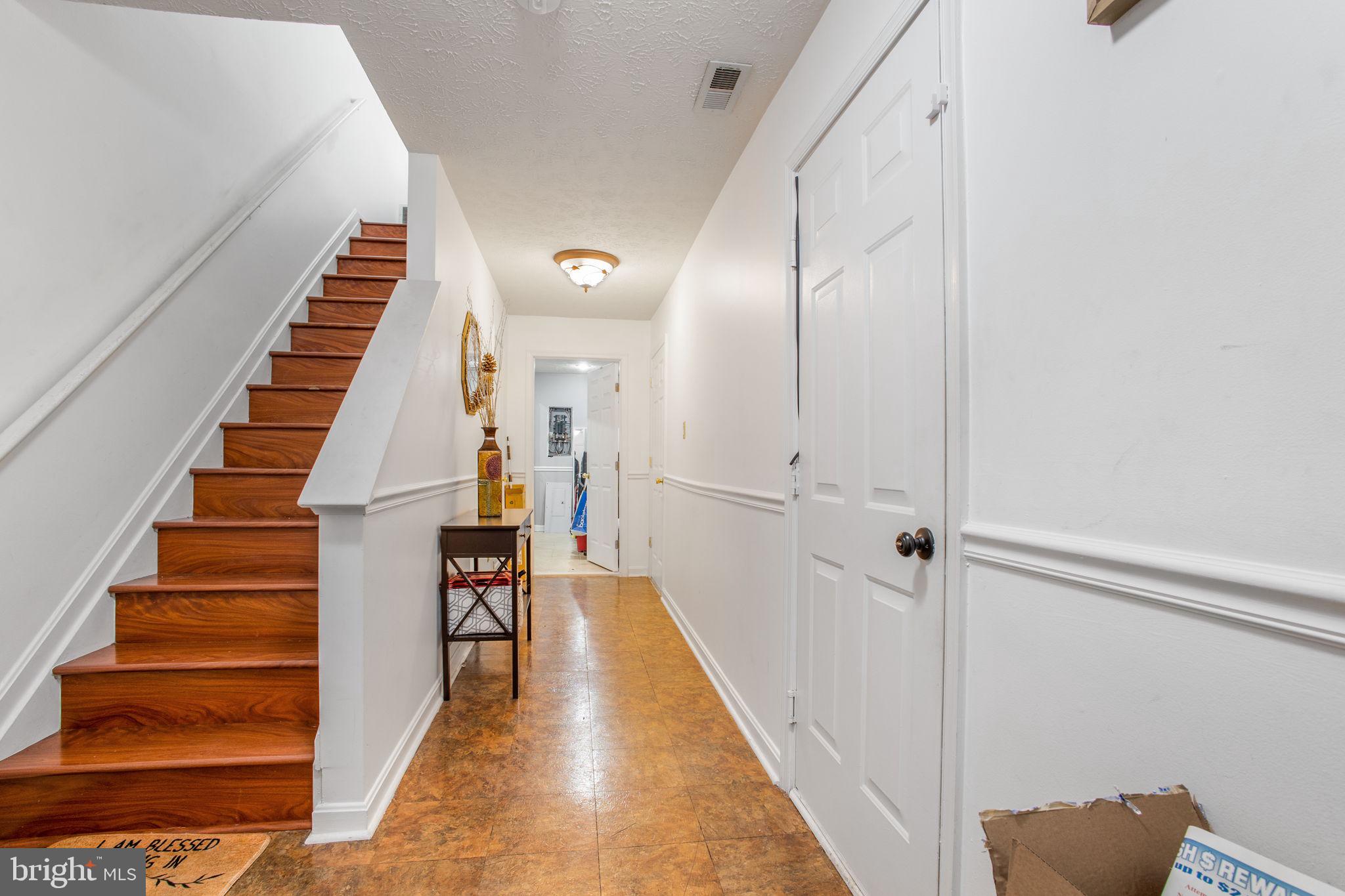 9820 Berrywood Court Bowie, MD 20721 - Photo 14 of 43 a view of a hallway with wooden floor and entryway