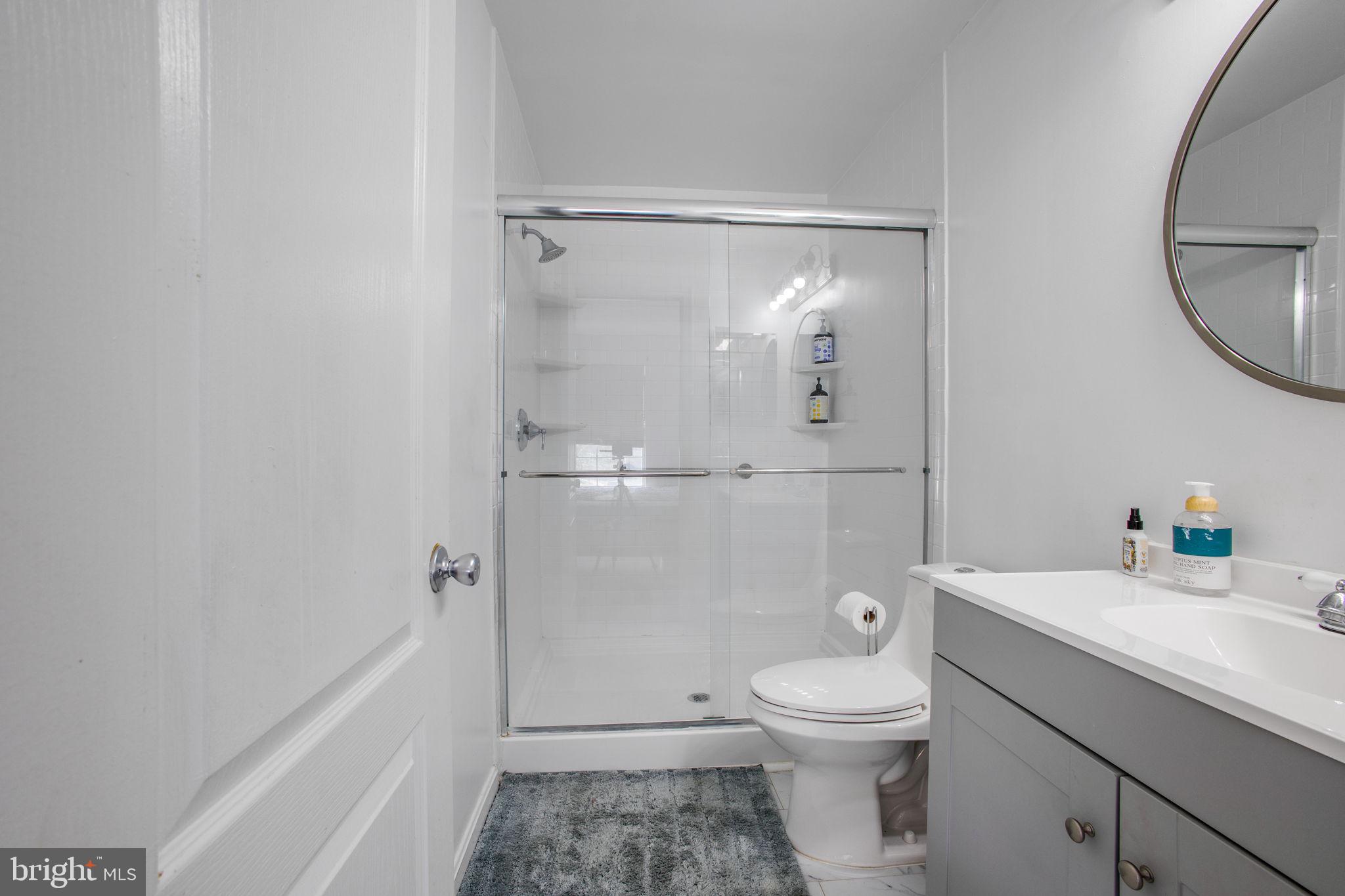 9820 Berrywood Court Bowie, MD 20721 - Photo 18 of 43 a bathroom with a granite countertop toilet a sink and a mirror