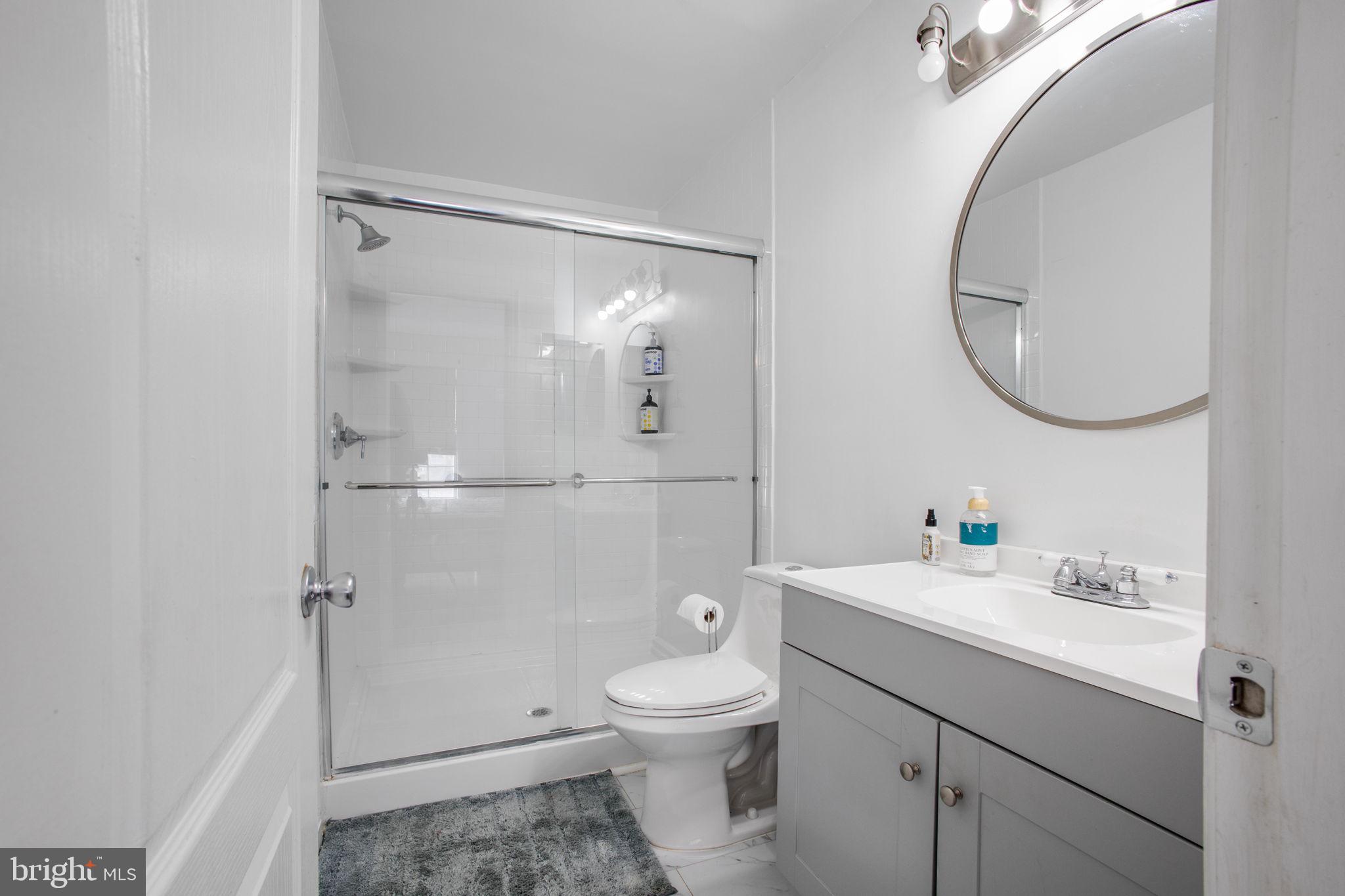9820 Berrywood Court Bowie, MD 20721 - Photo 20 of 43 a bathroom with a toilet a sink and a mirror