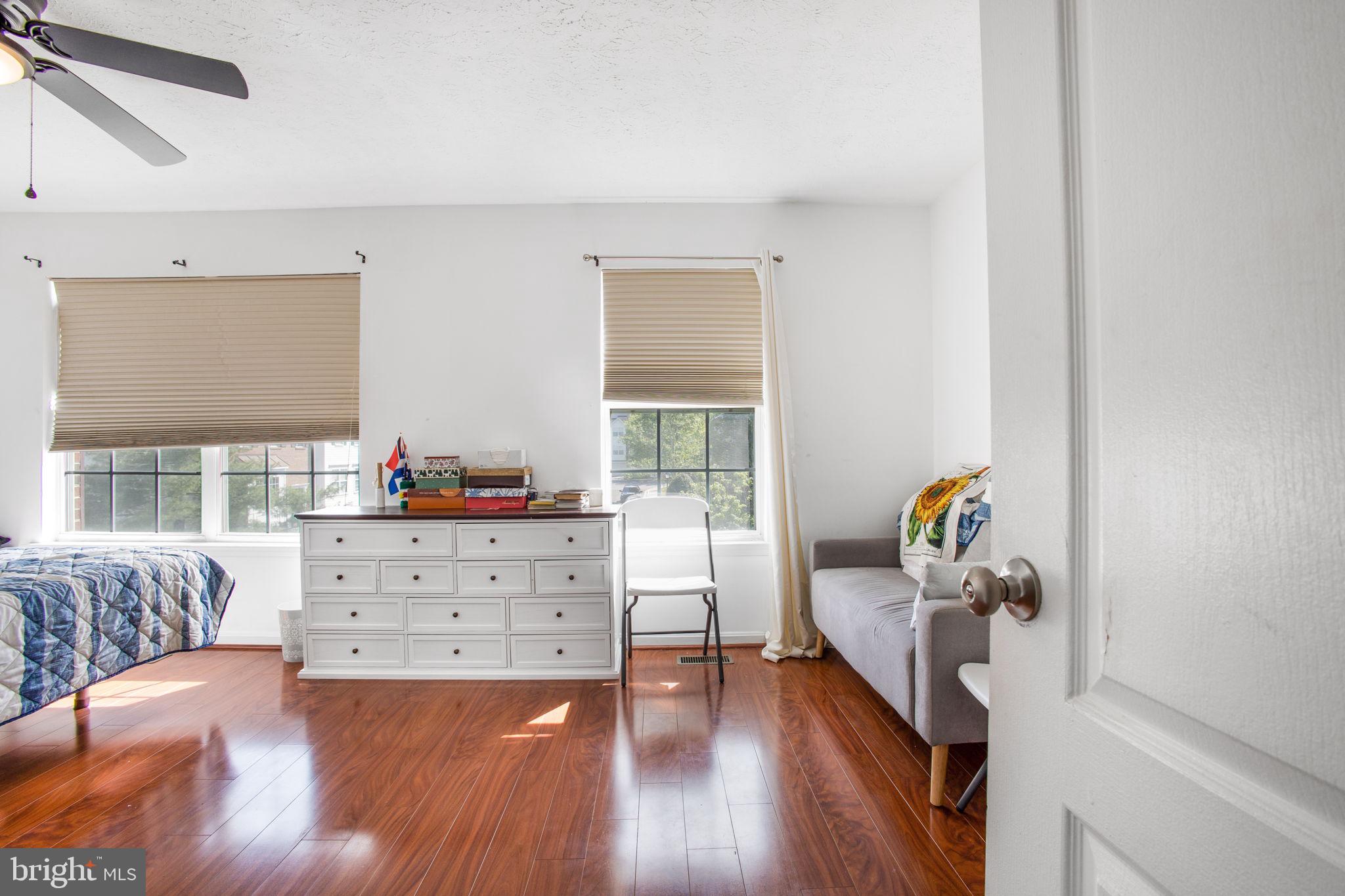 9820 Berrywood Court Bowie, MD 20721 - Photo 24 of 43 a bedroom with furniture and a wooden floor