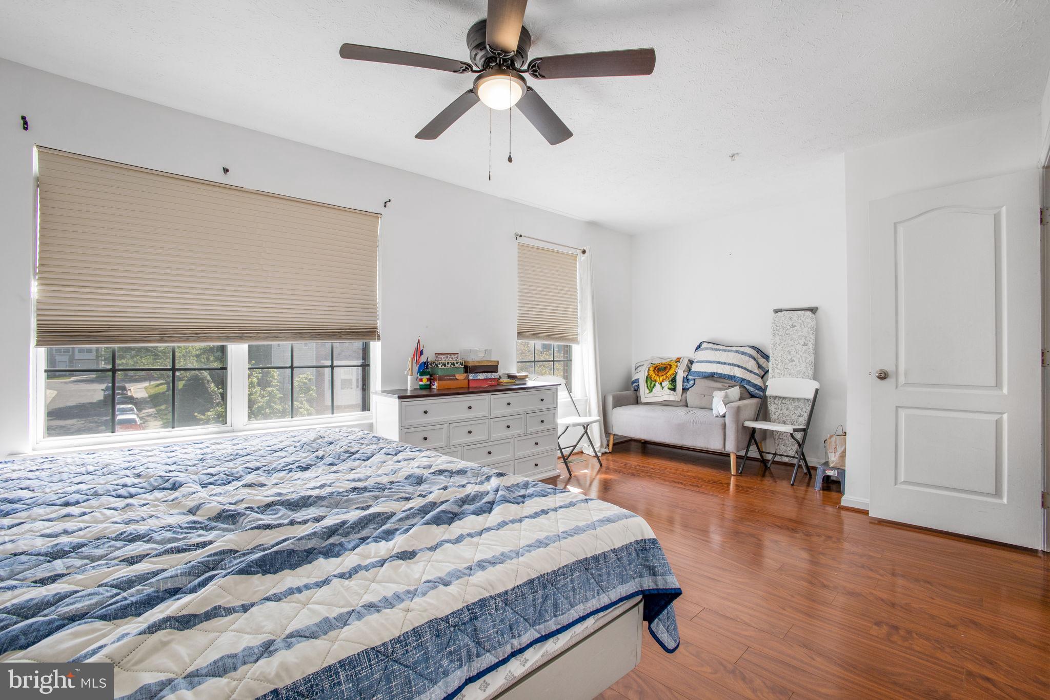 9820 Berrywood Court Bowie, MD 20721 - Photo 30 of 43 a bedroom with a bed and wooden floor