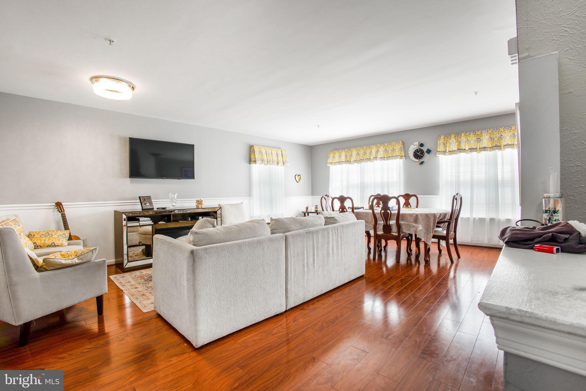 9820 Berrywood Court Bowie, MD 20721 - Photo 35 of 43 a living room with furniture and a flat screen tv