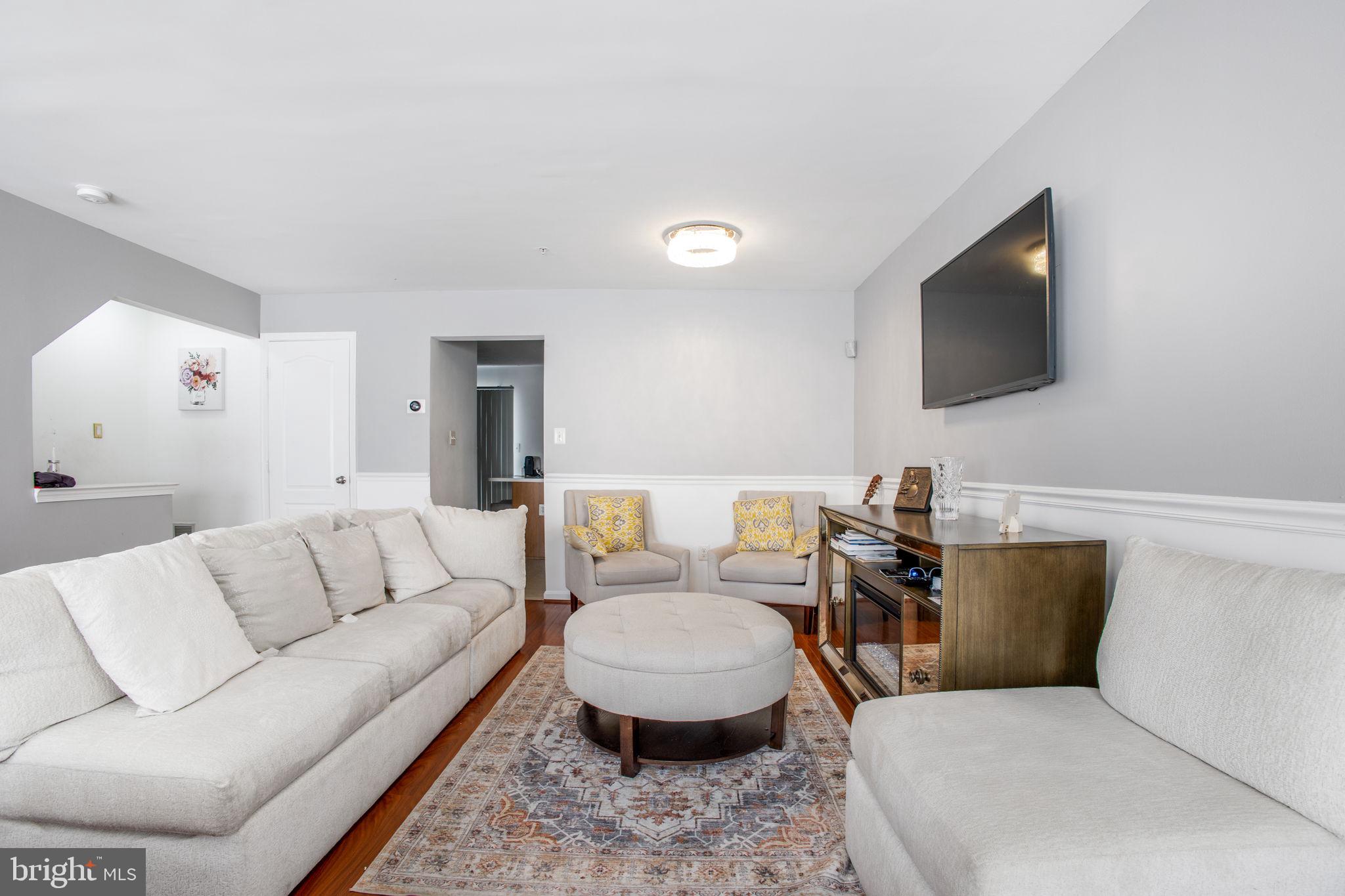 9820 Berrywood Court Bowie, MD 20721 - Photo 39 of 43 a living room with furniture and a flat screen tv