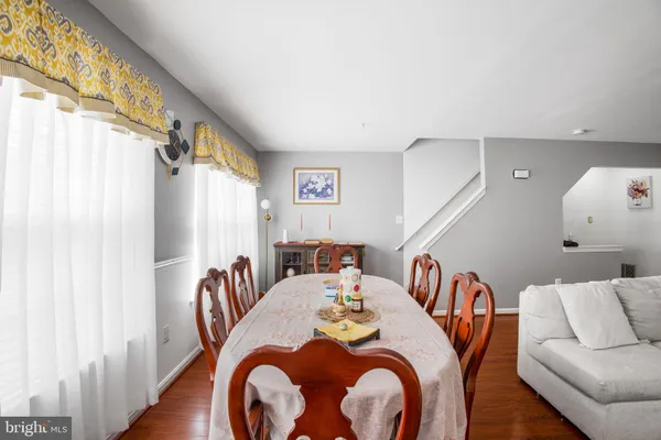 a dining room with furniture and a large window
