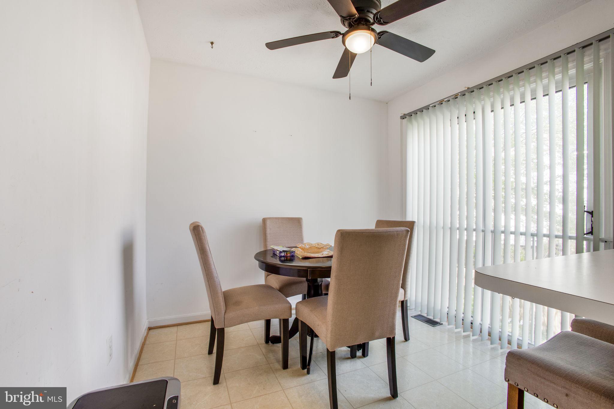 9820 Berrywood Court Bowie, MD 20721 - Photo 43 of 43 a view of a dining room with furniture and a window