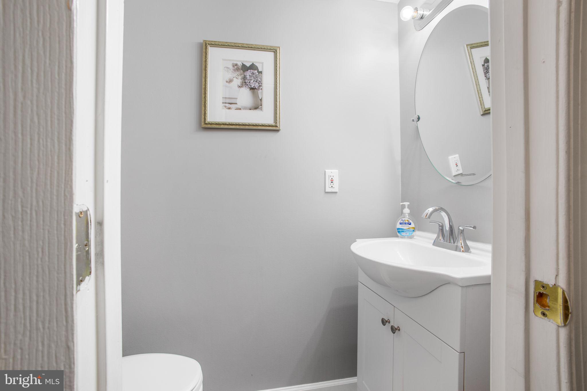 9820 Berrywood Court Bowie, MD 20721 - Photo 9 of 43 a bathroom with a toilet sink and mirror