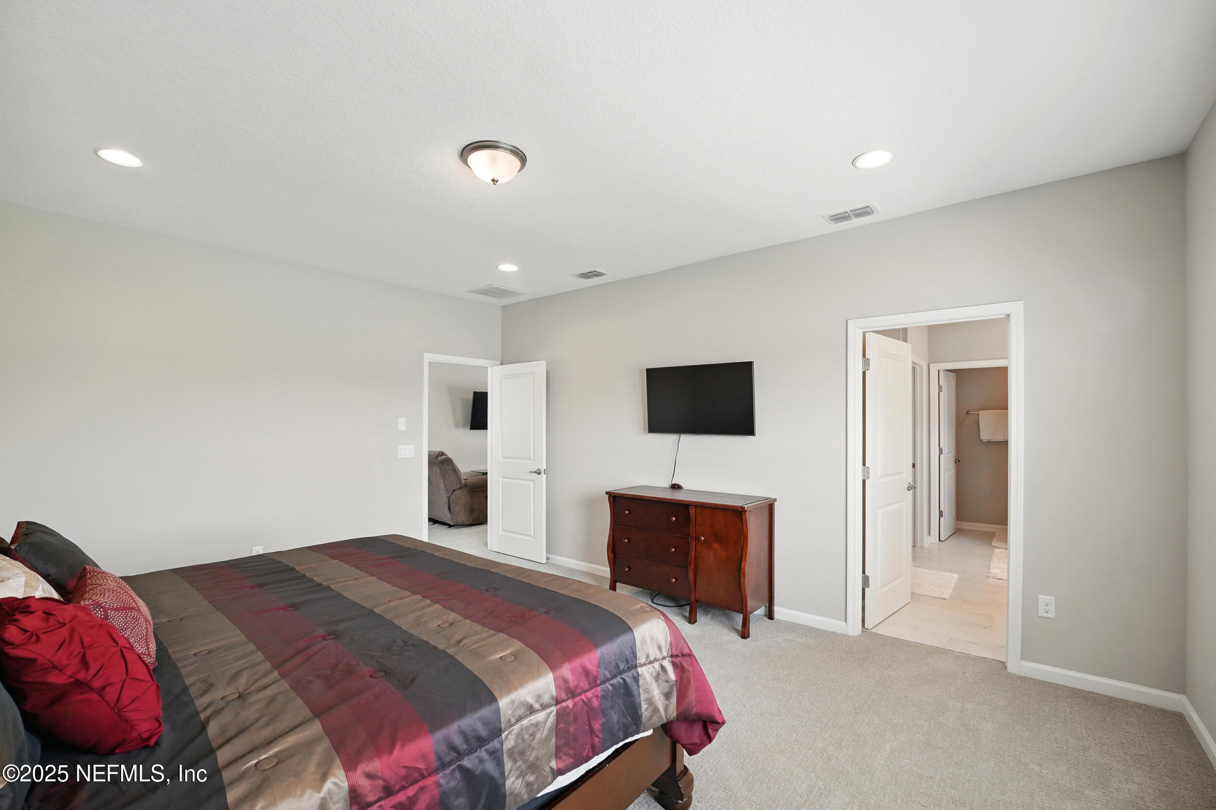 523 Silver Landing Drive St. Augustine, FL 32092 - Photo 26 of 63 a bedroom with a bed and a flat screen tv