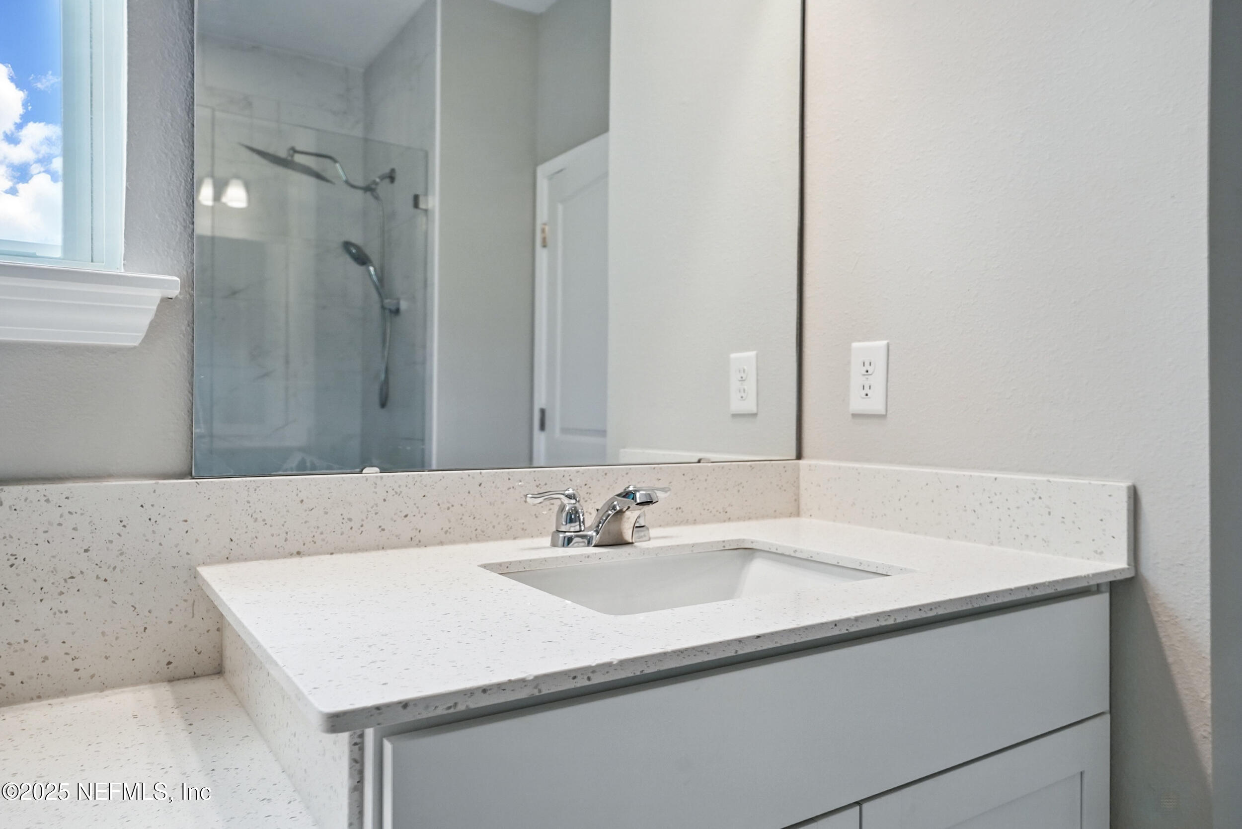 523 Silver Landing Drive St. Augustine, FL 32092 - Photo 29 of 63 a bathroom with a sink vanity and a mirror
