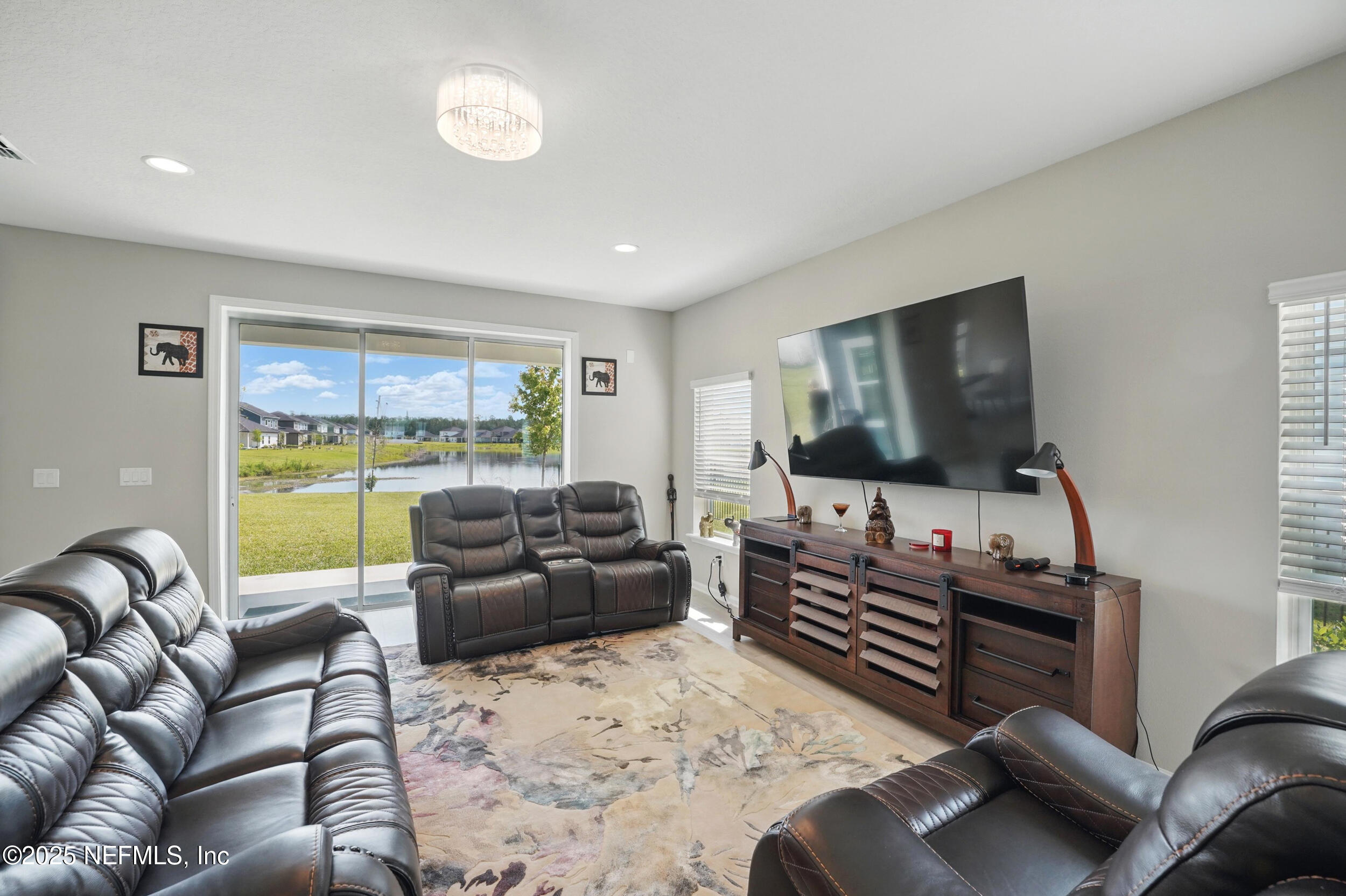 523 Silver Landing Drive St. Augustine, FL 32092 - Photo 6 of 63 a living room with furniture and a flat screen tv