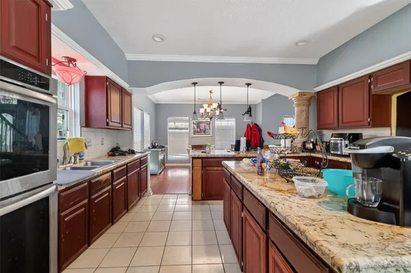 a kitchen with a sink stove top oven and cabinets