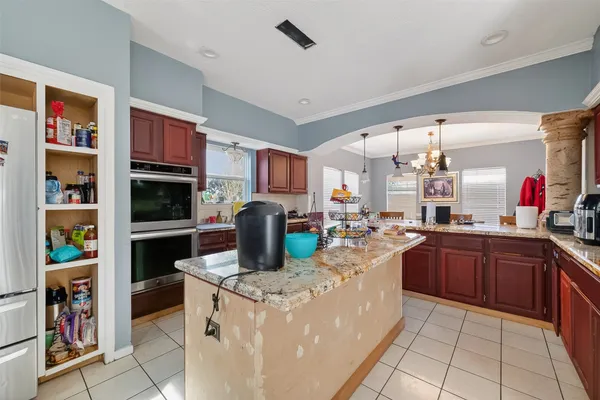 a kitchen with stainless steel appliances granite countertop a refrigerator and a stove