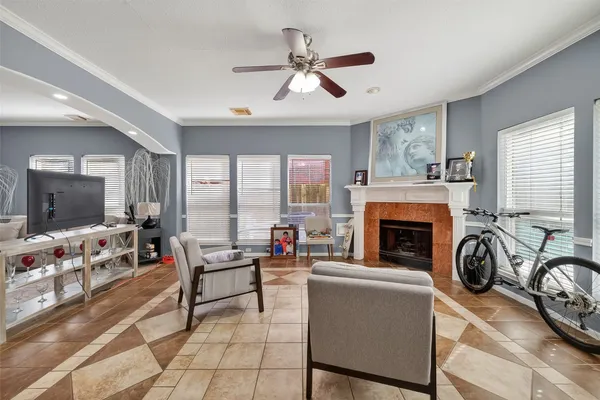 a living room with furniture a flat screen tv and a fireplace