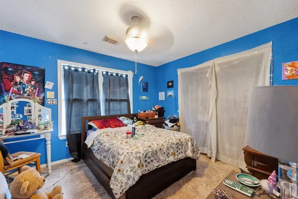 a bedroom with a bed and a large mirror