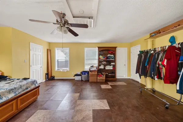 a bedroom with furniture and a flat screen tv