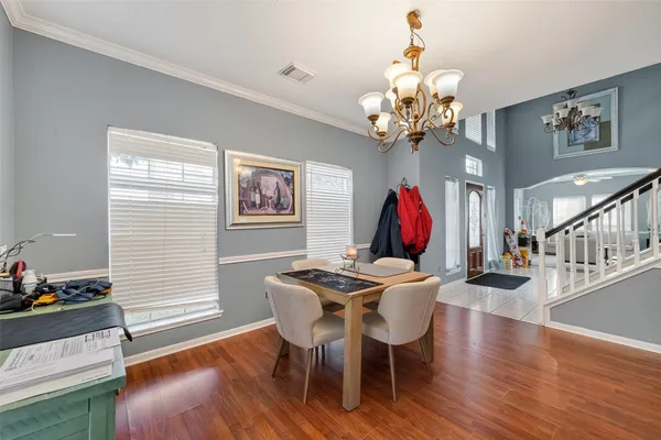 a view of a dining room with furniture wooden floor and chandelier