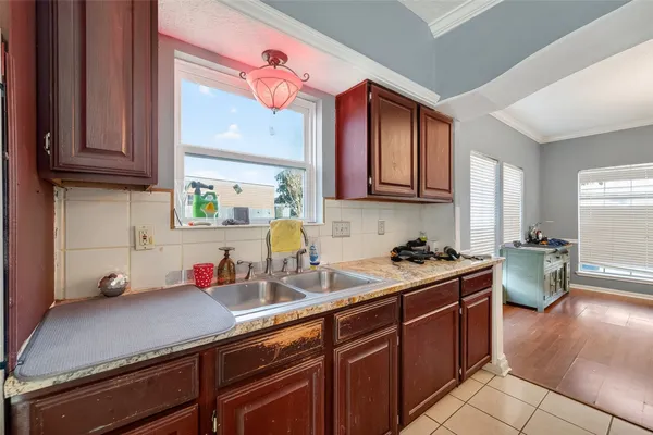 a kitchen with a sink cabinets and window