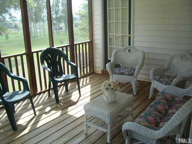 1133 Loop Road Clayton, NC 27527 - Photo 10 of 12 Sweet tea anyone? Cozy screened-in porch with magnificent, private view of award-winning golf course.