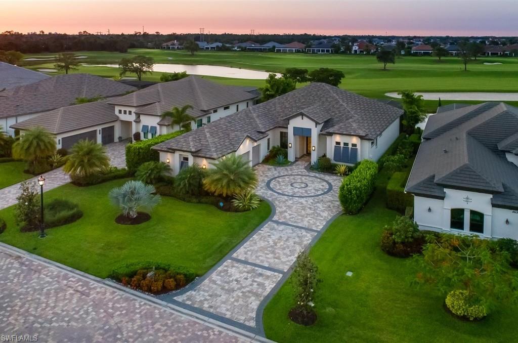 16337 Corsica Way Naples, FL 34110 - Photo 1 of 47 an aerial view of a house with outdoor space and lake view
