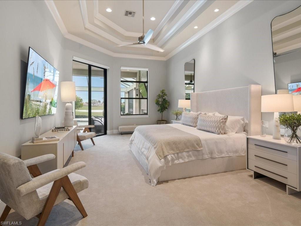 16337 Corsica Way Naples, FL 34110 - Photo 11 of 47 a spacious bedroom with a balcony a bed and a couch