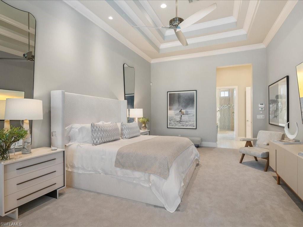 16337 Corsica Way Naples, FL 34110 - Photo 13 of 47 a bedroom with a bed and a chandelier
