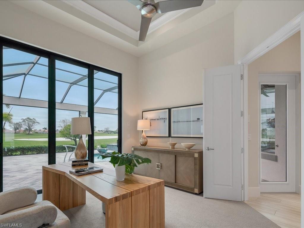 16337 Corsica Way Naples, FL 34110 - Photo 15 of 47 a room with kitchen island a large window in it