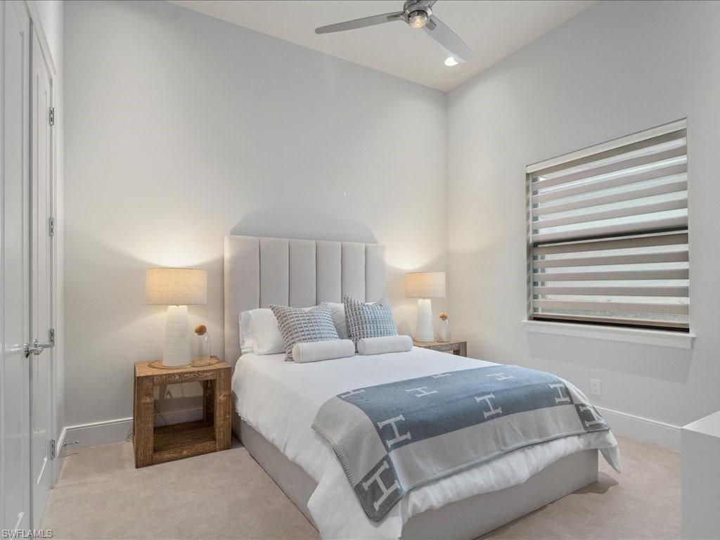 16337 Corsica Way Naples, FL 34110 - Photo 19 of 47 a bedroom with a bed and a night stand