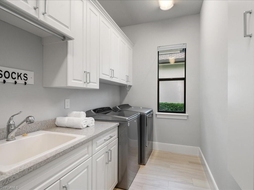 16337 Corsica Way Naples, FL 34110 - Photo 23 of 47 a kitchen with stainless steel appliances granite countertop a sink and a stove
