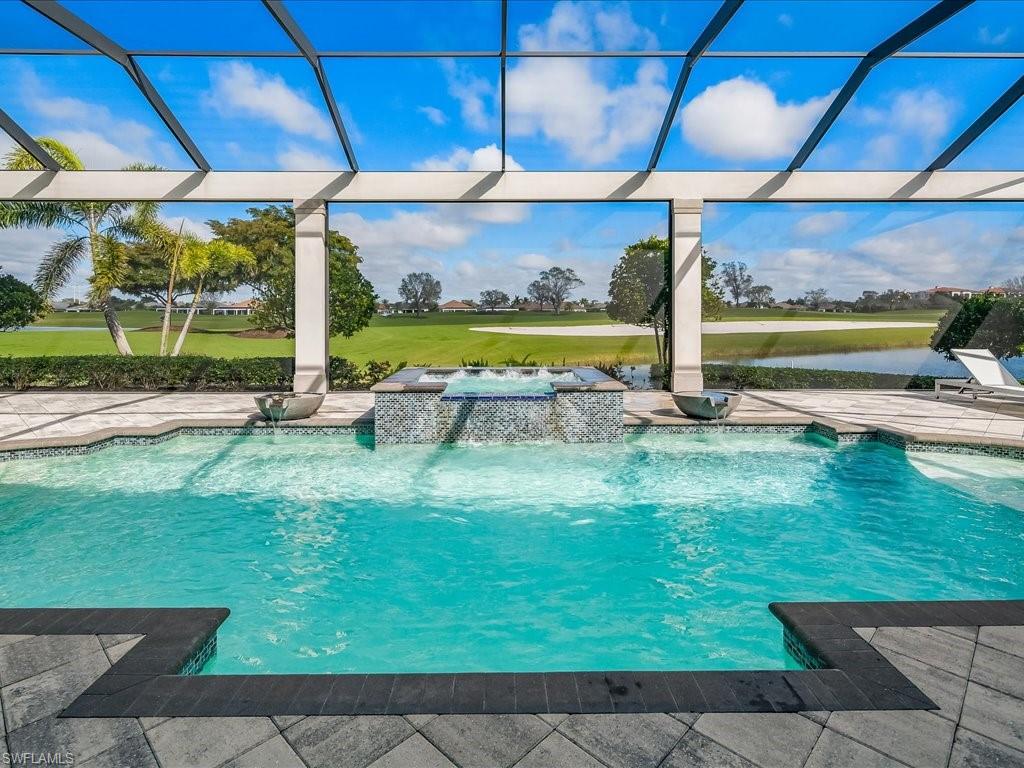 16337 Corsica Way Naples, FL 34110 - Photo 25 of 47 a view of a swimming pool with a yard