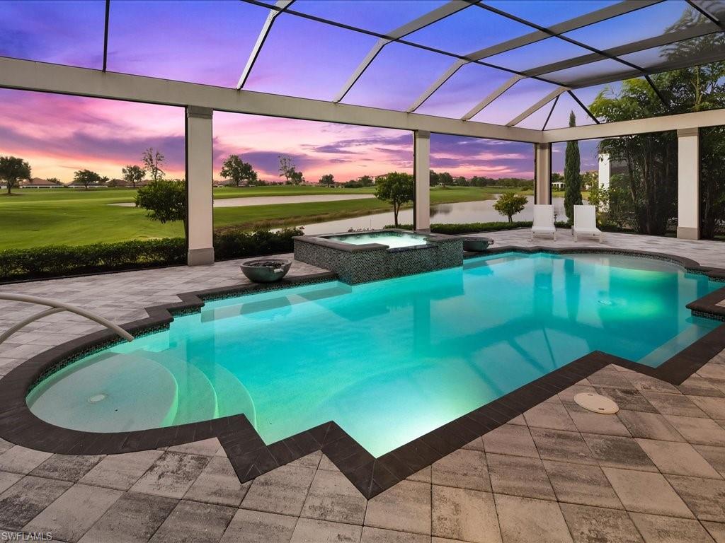 16337 Corsica Way Naples, FL 34110 - Photo 30 of 47 a view of a swimming pool with a patio