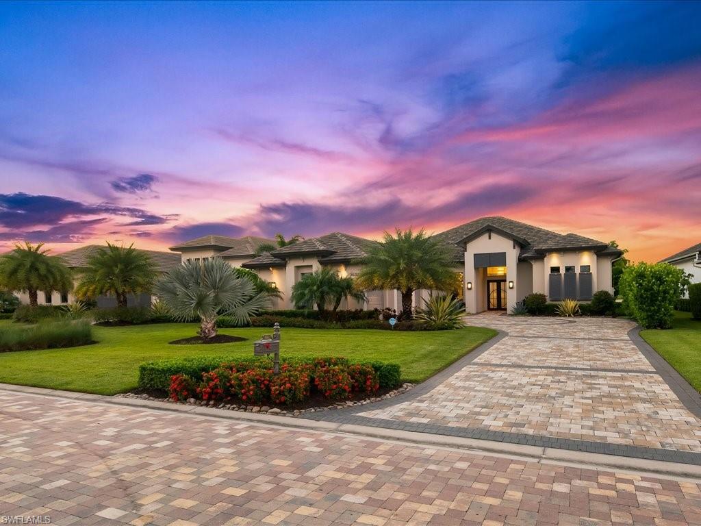 16337 Corsica Way Naples, FL 34110 - Photo 3 of 47 a front view of a house with a yard