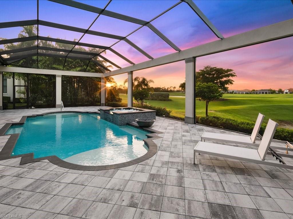 16337 Corsica Way Naples, FL 34110 - Photo 34 of 47 a view of a swimming pool with a patio