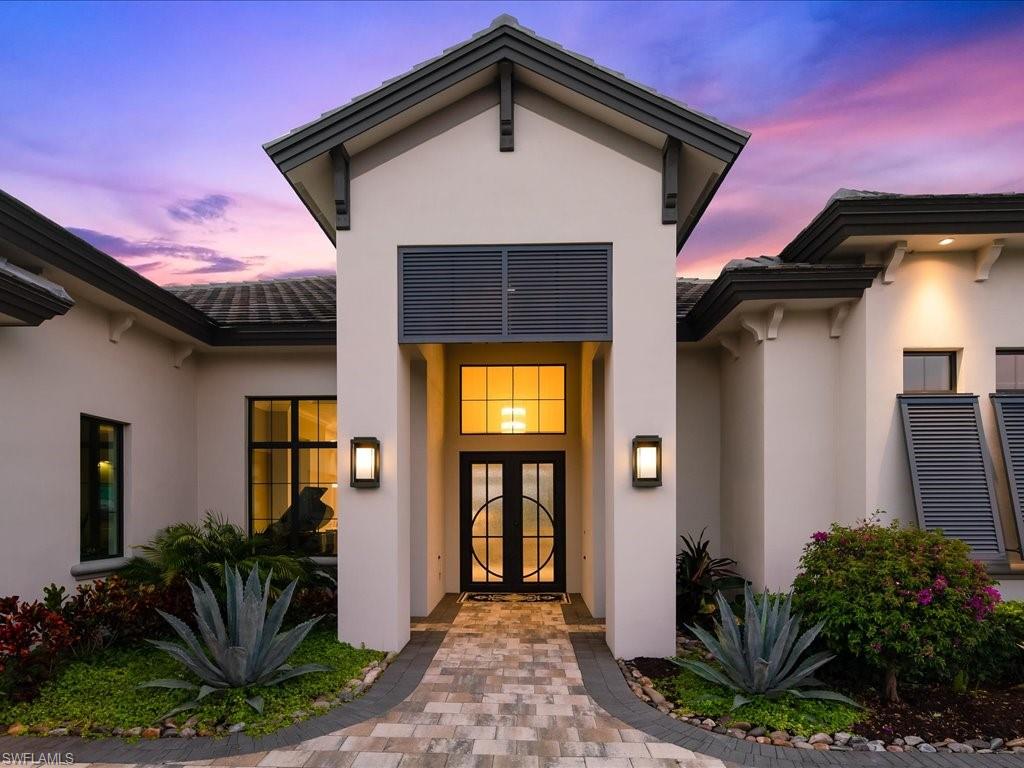 16337 Corsica Way Naples, FL 34110 - Photo 35 of 47 a front view of a house with garden