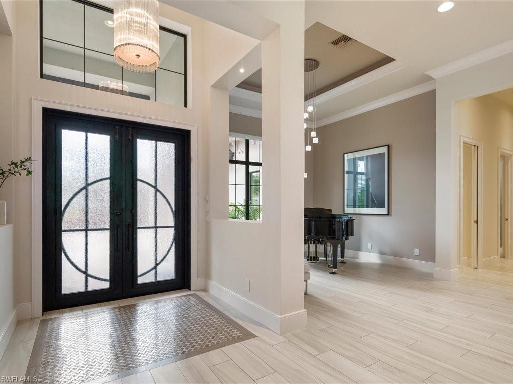 16337 Corsica Way Naples, FL 34110 - Photo 4 of 47 a view of an entryway with wooden floor