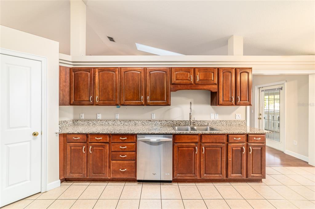 9611 Southwest 45th Avenue Ocala, FL 34476 - Photo 16 of 56 a kitchen with stainless steel appliances granite countertop a sink and cabinets